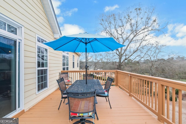 wooden deck featuring outdoor dining space