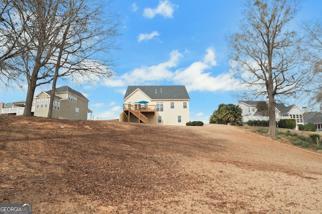 rear view of house with a wooden deck