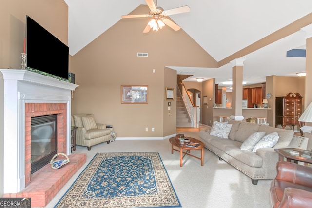 living room featuring light colored carpet, visible vents, baseboards, stairs, and a brick fireplace