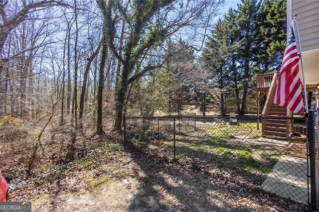 view of yard with fence and stairway