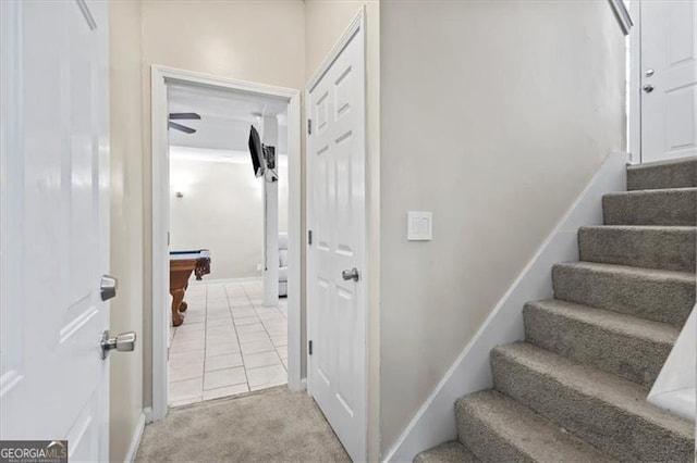 stairway featuring carpet floors, billiards, baseboards, and tile patterned floors