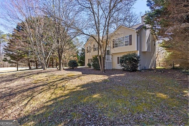 view of property exterior featuring a chimney