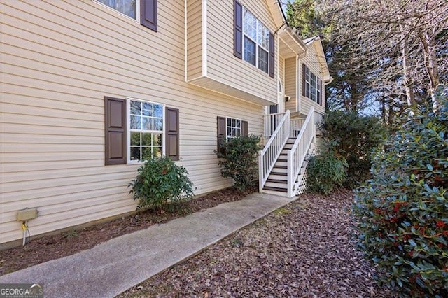 view of side of property featuring stairs