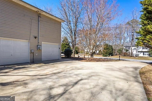 exterior space featuring a garage and concrete driveway