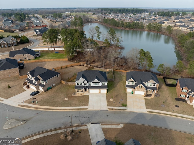 bird's eye view with a water view and a residential view