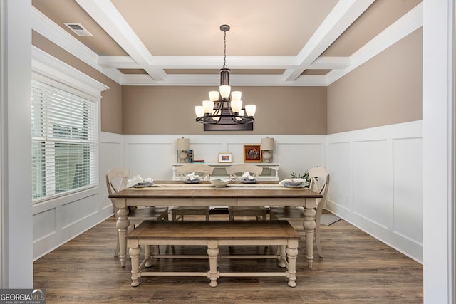 dining space featuring a decorative wall, a notable chandelier, coffered ceiling, visible vents, and beamed ceiling