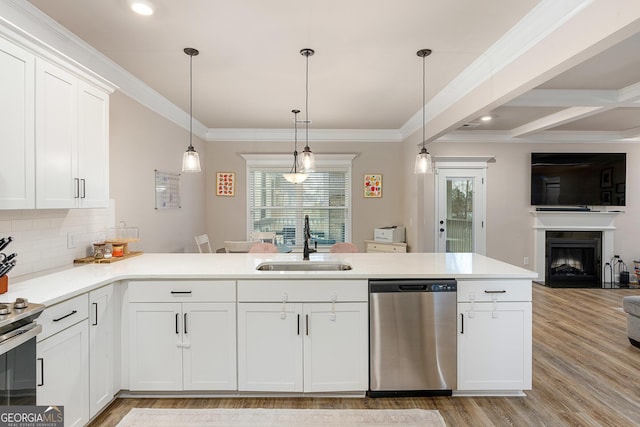 kitchen with tasteful backsplash, open floor plan, stainless steel appliances, crown molding, and a sink