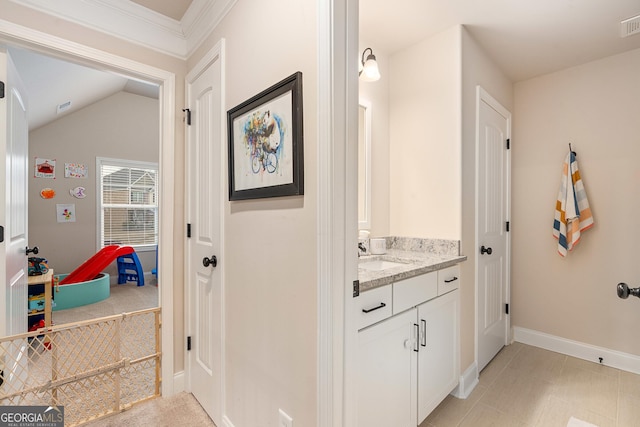 bathroom featuring visible vents, lofted ceiling, vanity, and baseboards