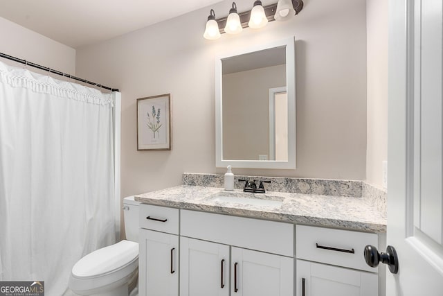 full bathroom featuring vanity and toilet