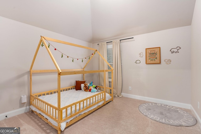 bedroom featuring vaulted ceiling, carpet, and baseboards