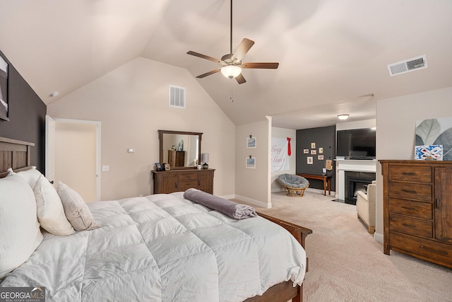 carpeted bedroom featuring high vaulted ceiling, a fireplace with flush hearth, visible vents, and baseboards