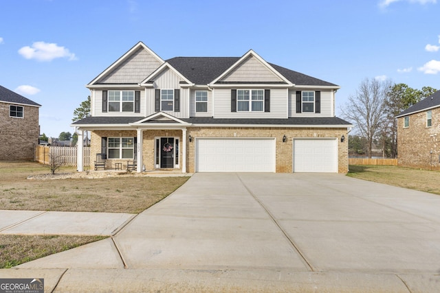 view of front of house with brick siding, concrete driveway, an attached garage, board and batten siding, and fence