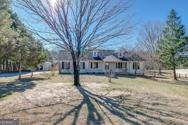 cape cod house with a front lawn and a porch