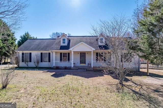 cape cod home with covered porch, roof with shingles, and a front lawn