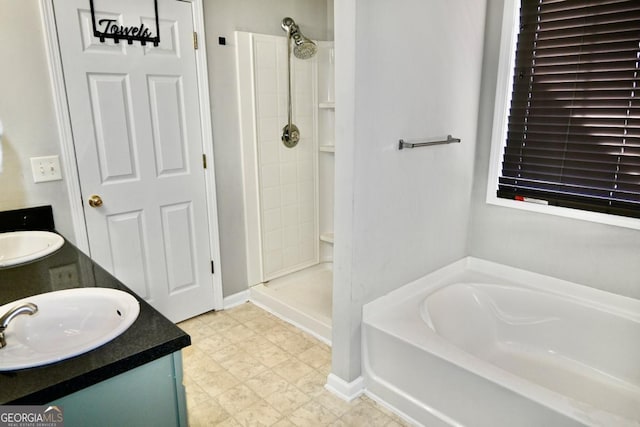 full bath with a garden tub, a tile shower, vanity, and tile patterned floors