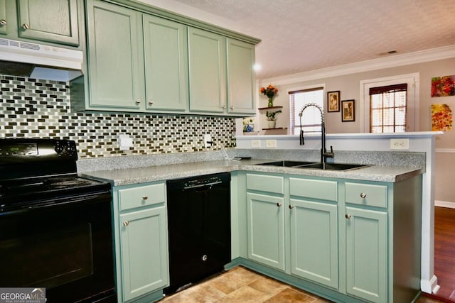 kitchen featuring black appliances, under cabinet range hood, and green cabinetry