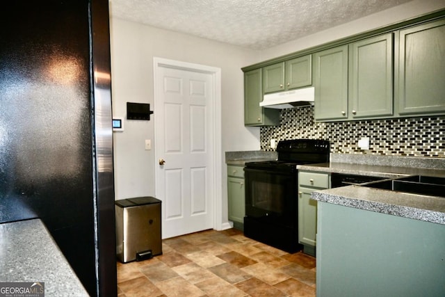 kitchen with a textured ceiling, under cabinet range hood, green cabinets, decorative backsplash, and black appliances