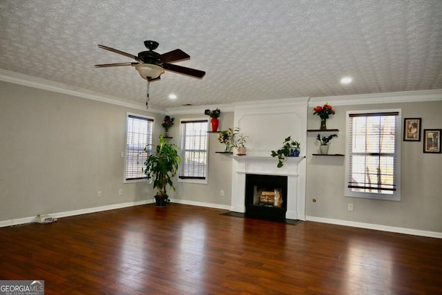 unfurnished living room with a fireplace with flush hearth, crown molding, baseboards, and wood finished floors