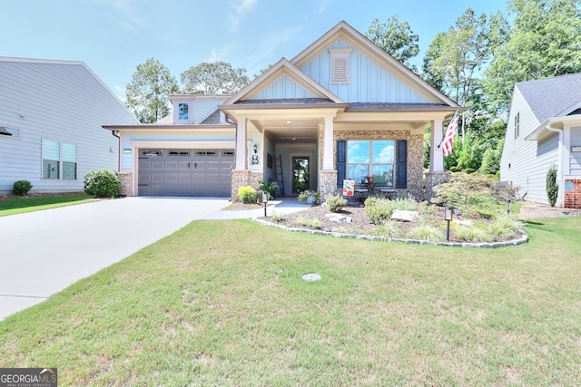 craftsman inspired home with a garage, brick siding, driveway, a front lawn, and board and batten siding