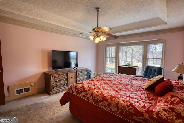 bedroom with visible vents, a ceiling fan, light colored carpet, crown molding, and a textured ceiling