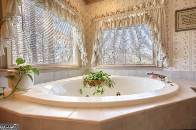 full bath with a whirlpool tub and wallpapered walls