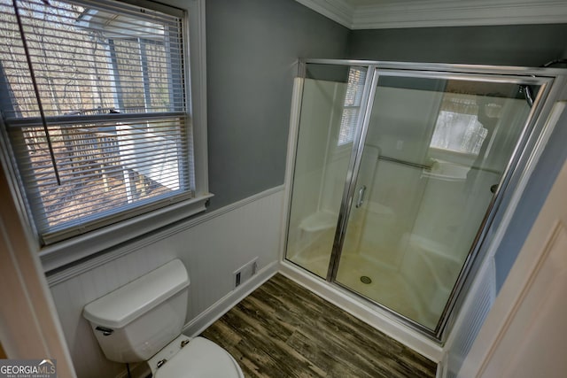 full bathroom featuring a stall shower, visible vents, toilet, a wainscoted wall, and wood finished floors