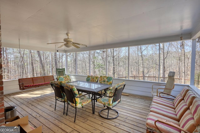 sunroom featuring a ceiling fan