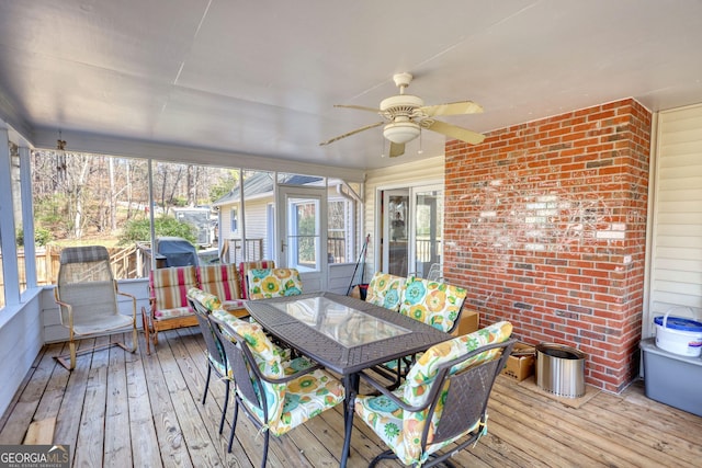 sunroom featuring ceiling fan