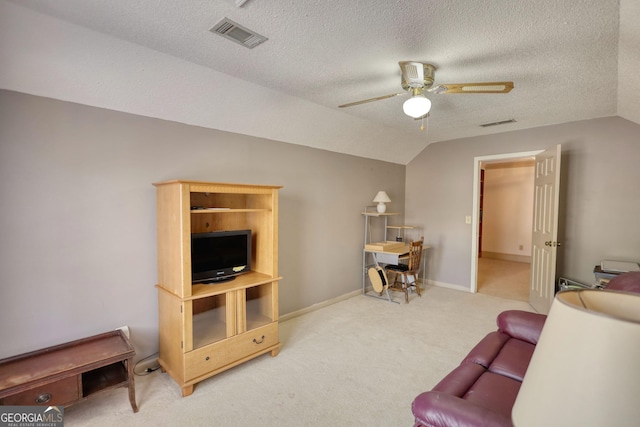 carpeted living area with lofted ceiling, ceiling fan, visible vents, and a textured ceiling