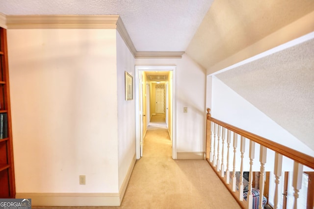 corridor with a textured ceiling, light carpet, baseboards, and crown molding