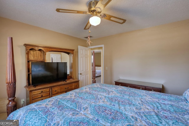 bedroom featuring a textured ceiling and a ceiling fan