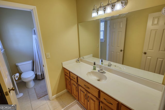 bathroom featuring toilet, tile patterned flooring, vanity, and baseboards