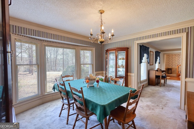 dining room featuring light carpet, wallpapered walls, plenty of natural light, ornamental molding, and a textured ceiling