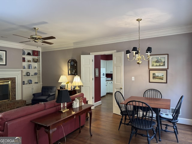 dining room with ornamental molding, a brick fireplace, dark wood finished floors, and baseboards