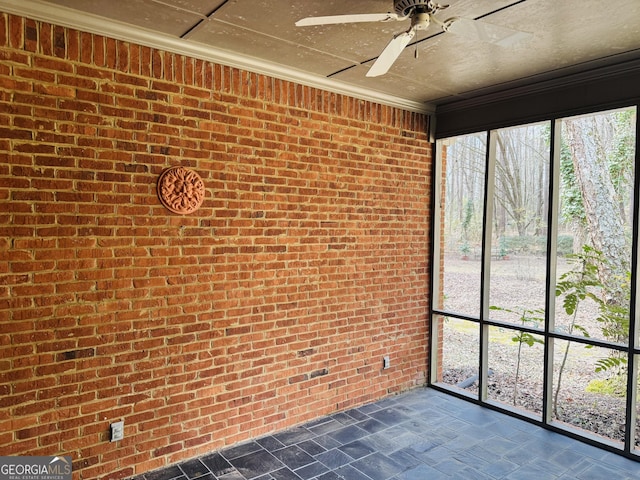 unfurnished sunroom with a ceiling fan