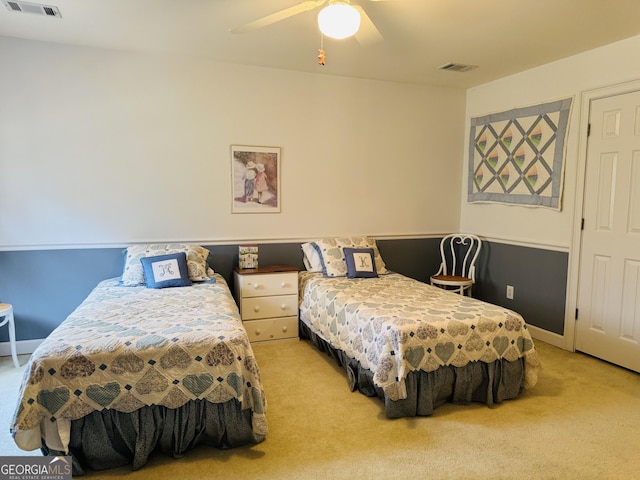 bedroom with light carpet, ceiling fan, and visible vents