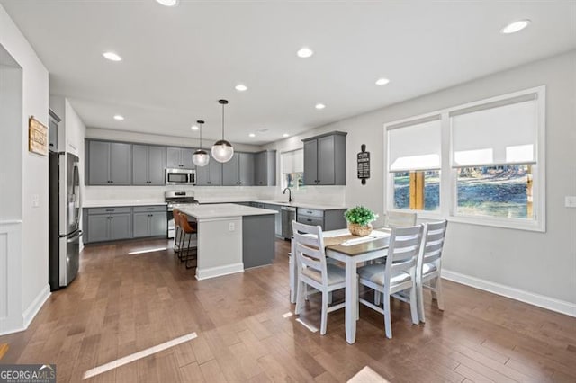 dining area with baseboards, dark wood-style flooring, and recessed lighting