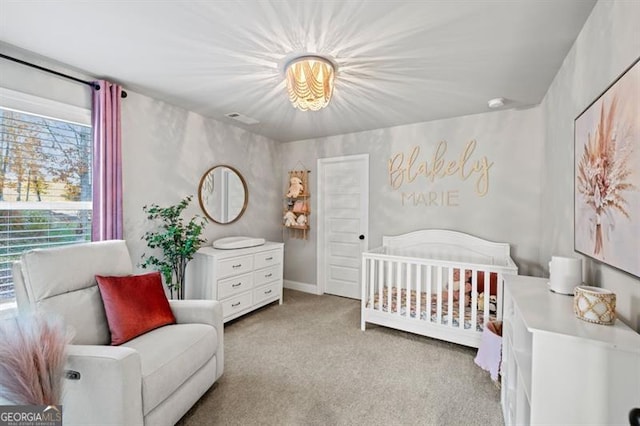 carpeted bedroom with a nursery area and visible vents