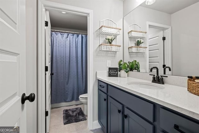 full bathroom with curtained shower, vanity, and toilet