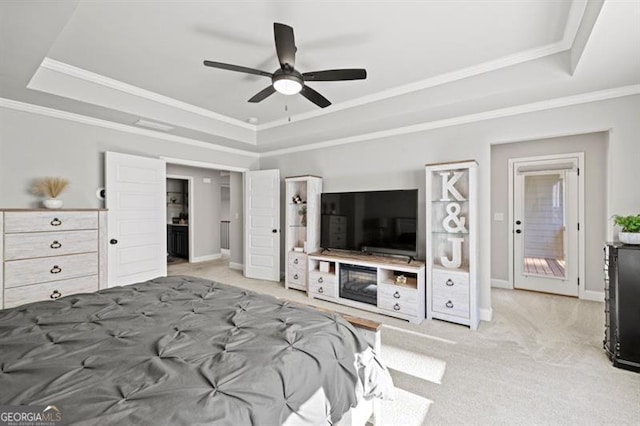 bedroom with ornamental molding, a raised ceiling, carpet flooring, and baseboards