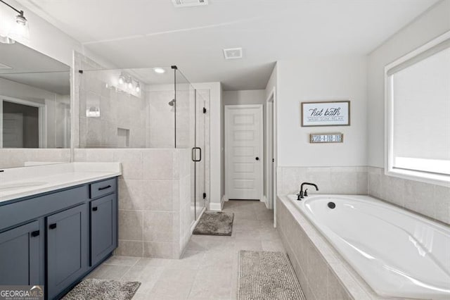 full bath with visible vents, a shower stall, vanity, tile patterned flooring, and a bath