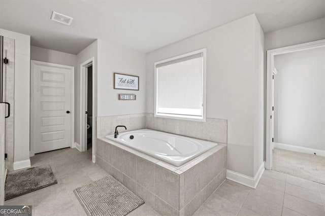 bathroom with a garden tub, visible vents, a shower stall, baseboards, and tile patterned floors