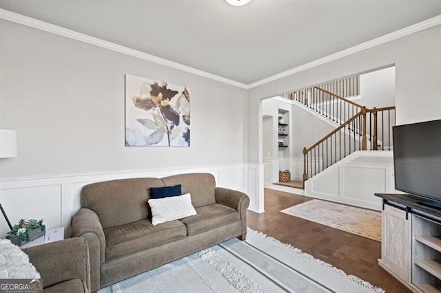 living area featuring a wainscoted wall, stairs, ornamental molding, and wood finished floors