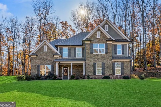 craftsman house with stone siding and a front lawn