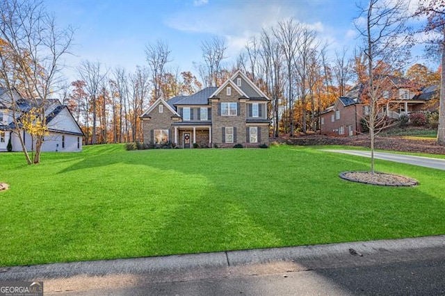 view of front of property featuring stone siding and a front lawn