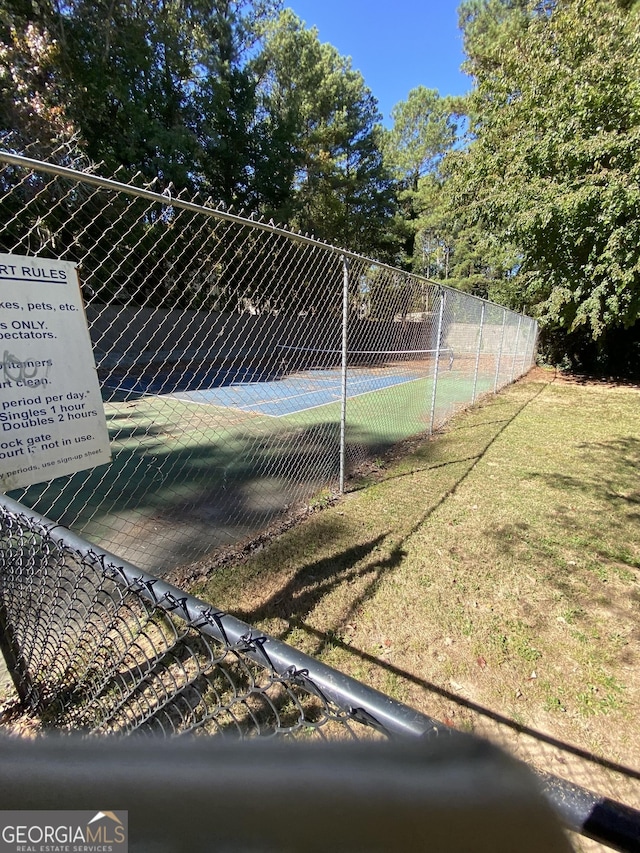 view of sport court featuring fence