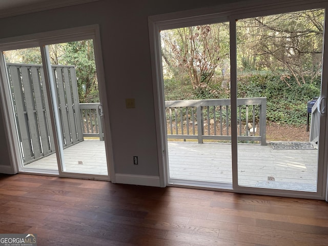 doorway to outside featuring hardwood / wood-style flooring and baseboards