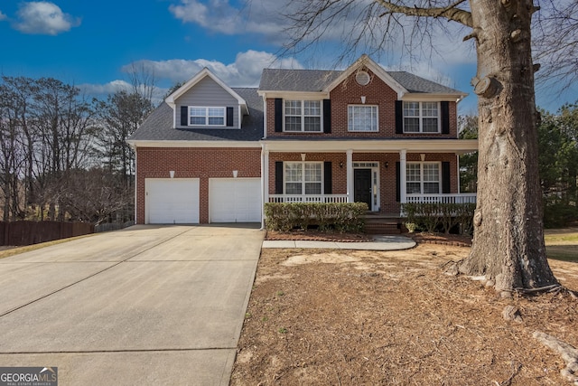 colonial-style house with a porch, an attached garage, brick siding, driveway, and roof with shingles