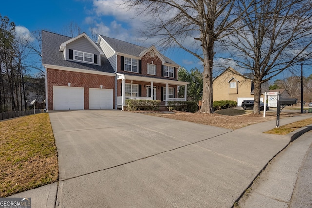 view of front facade with an attached garage, covered porch, brick siding, a shingled roof, and concrete driveway