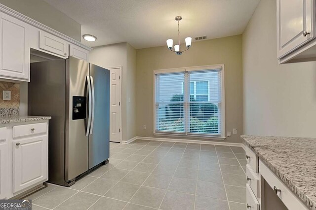 kitchen featuring tasteful backsplash, visible vents, stainless steel fridge with ice dispenser, an inviting chandelier, and white cabinetry